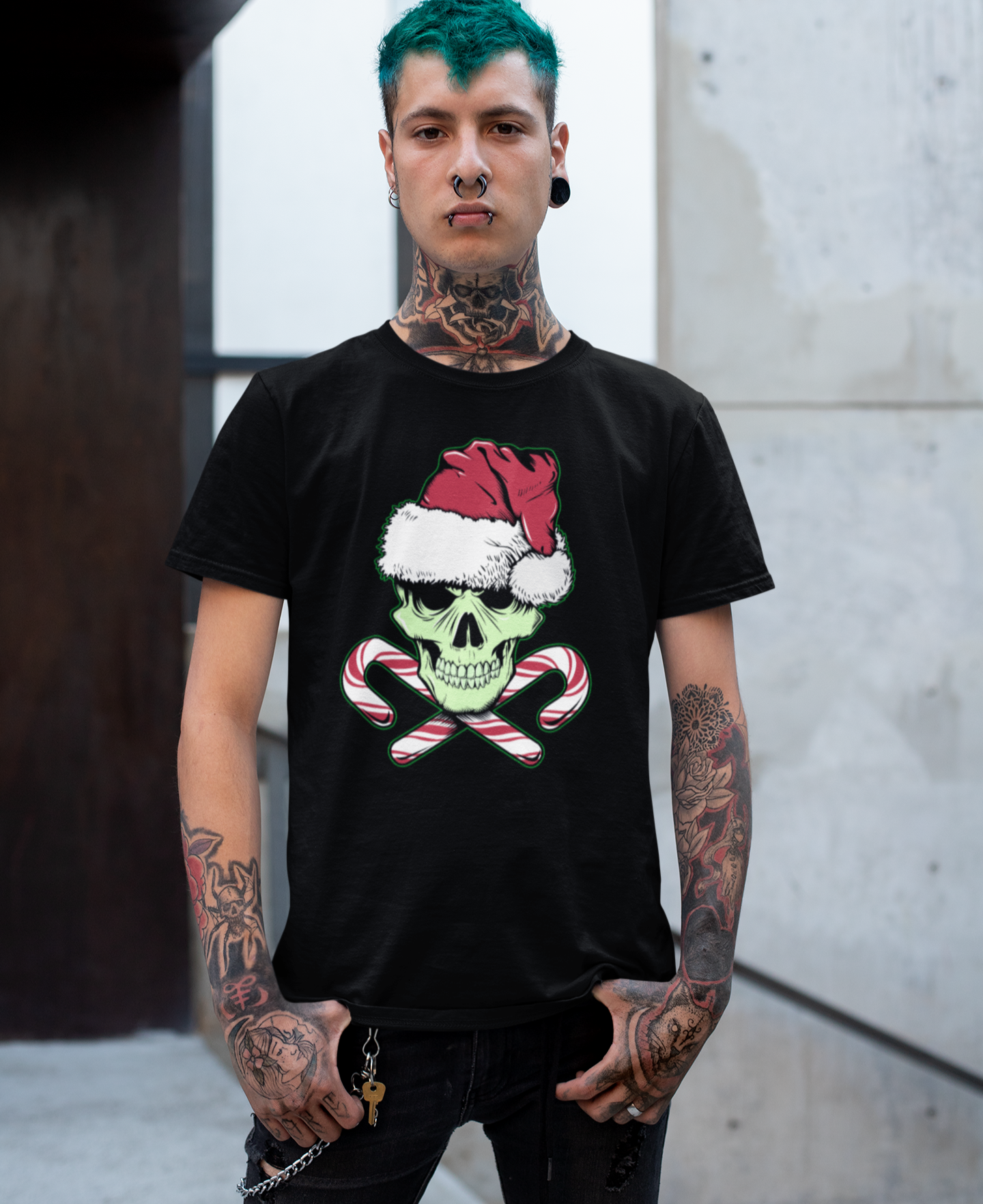 Person wearing a black t-shirt with a graphic design of a skull wearing a Santa hat and candy canes.